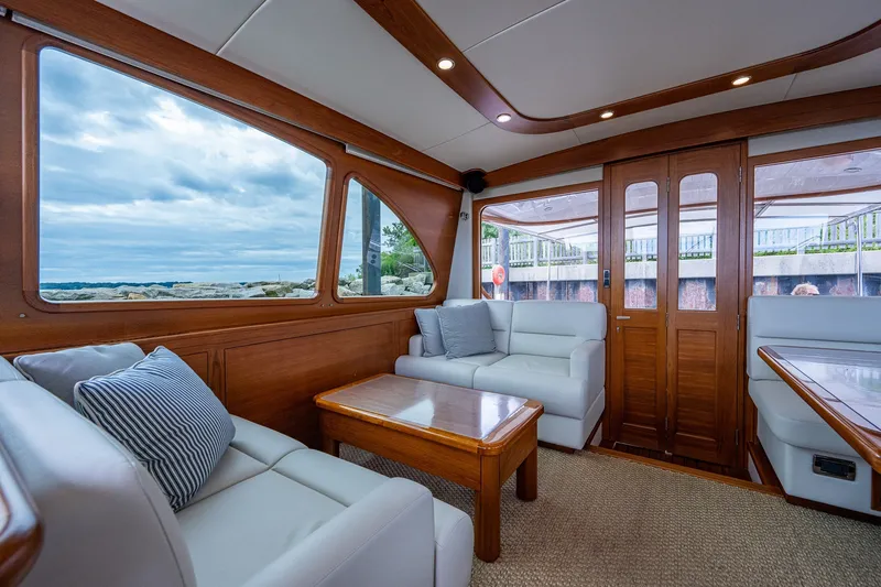 Slide: The Image of Luxurious interior of 2021 Palm Beach Motor Yachts PB55 with elegant wood finish and plush seating. - 17