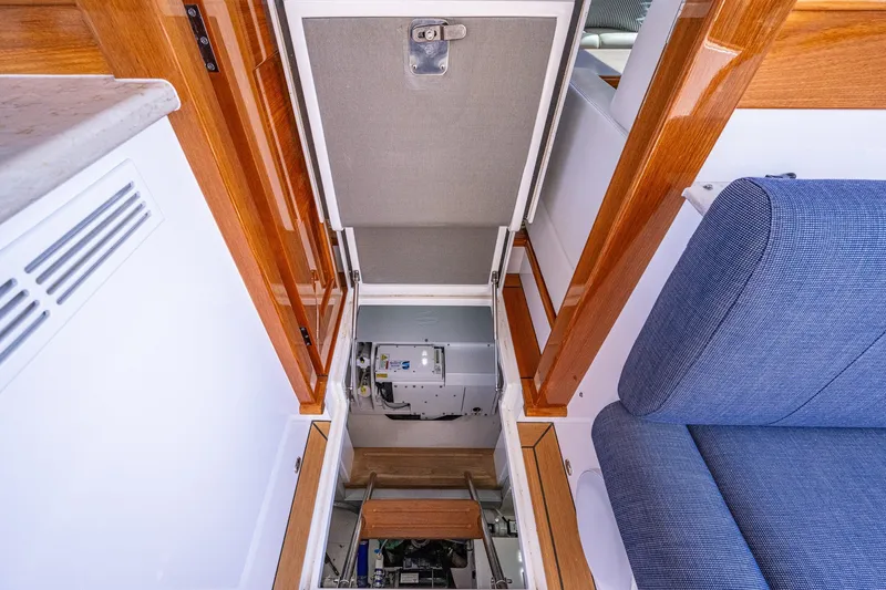 Slide: The Image of 2021 Palm Beach Motor Yachts PB55 interior with open hatch and blue seating. - 38