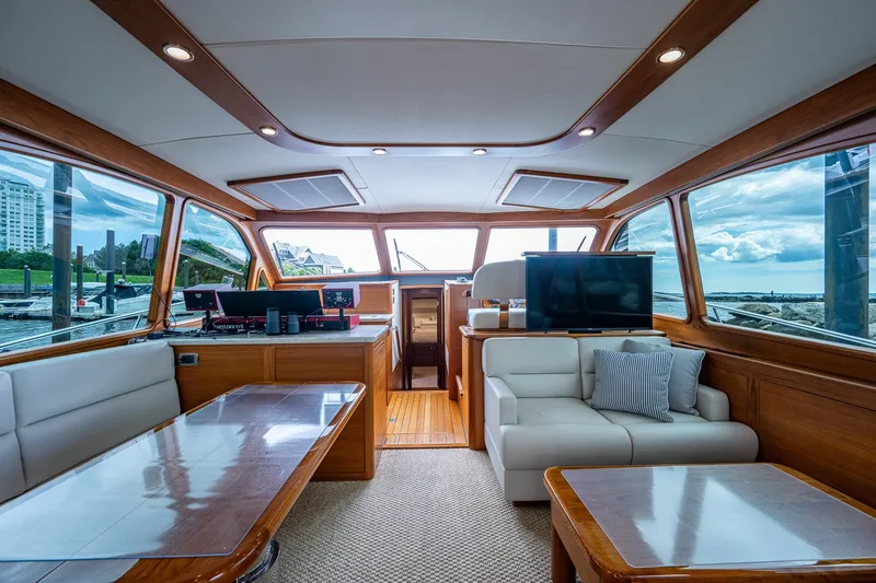 Slide: The Image of Luxurious interior of 2021 Palm Beach Motor Yachts PB55 with elegant wood finishes and plush seating. - 16