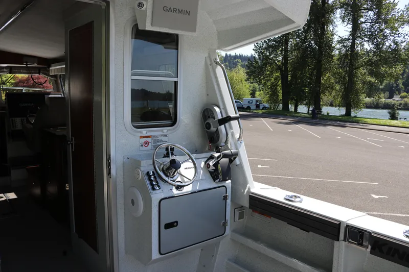 Slide: The Image of Interior view of 2026 KingFisher 3425 GFX Offshore boat with steering wheel and Garmin equipment. - 25