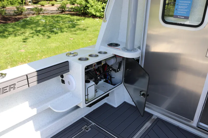 Slide: The Image of Interior view of 2026 KingFisher 3425 GFX Offshore boat with open storage compartment. - 28