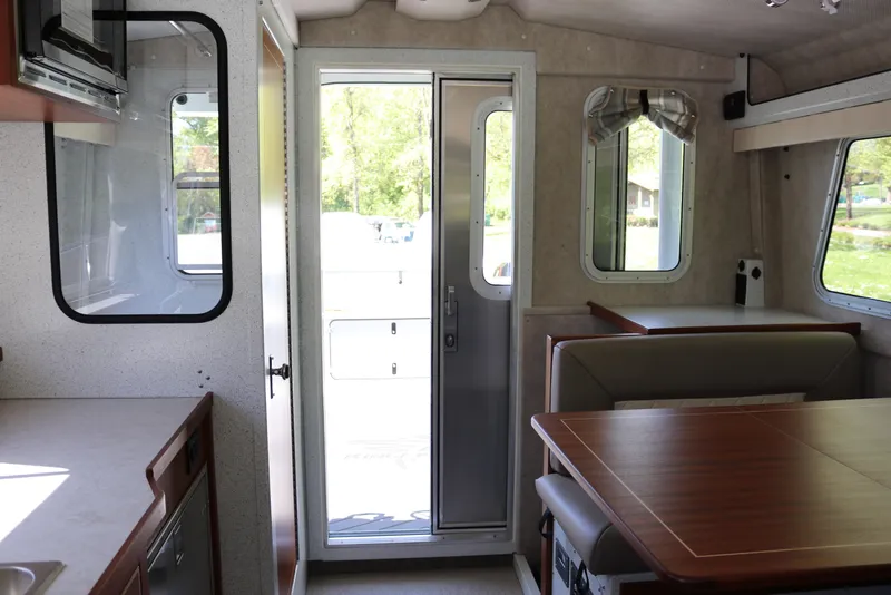 Slide: The Image of Interior of 2026 KingFisher 3425 GFX Offshore boat, featuring dining area and kitchenette. - 23