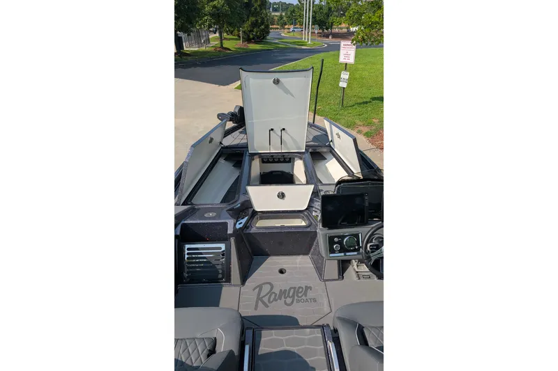 Slide: The Image of 2026 Ranger Z520R Ultra boat interior with open storage compartments and control panel. - 7