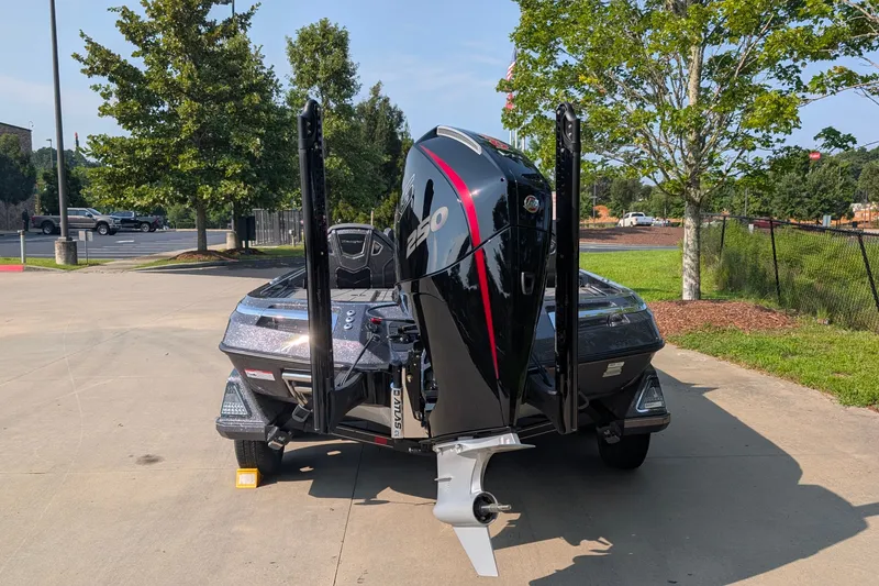 Slide: The Image of 2026 Ranger Z520R Ultra boat with powerful outboard motor, parked outdoors. - 16
