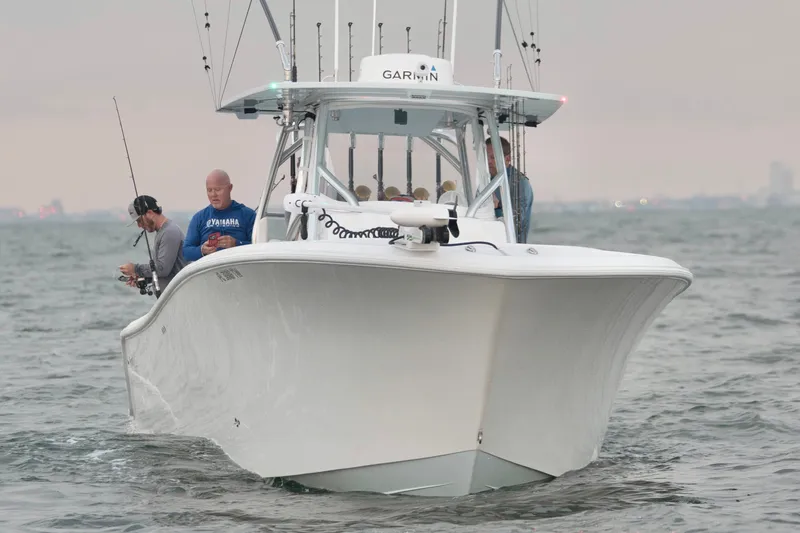 Slide: The Image of 2025 Front Runner 36 Center Console boat on water with anglers fishing. - 5