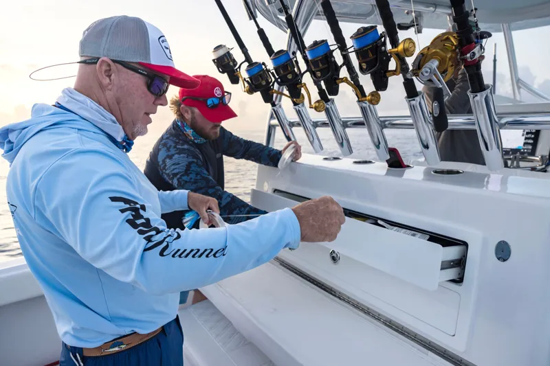 Slide: The Image of Two people fishing on a 2025 Front Runner 36 Center Console boat. - 14