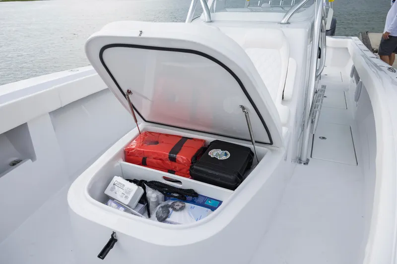 Slide: The Image of Storage compartment on 2025 Front Runner 36 Center Console boat, containing safety gear and equipment. - 10