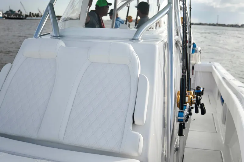 Slide: The Image of 2025 Front Runner 36 Center Console boat with white seating and fishing rods. - 12