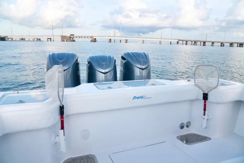 Slide: The Image of 2025 Front Runner 36 Center Console boat with triple engines on calm water. - 9