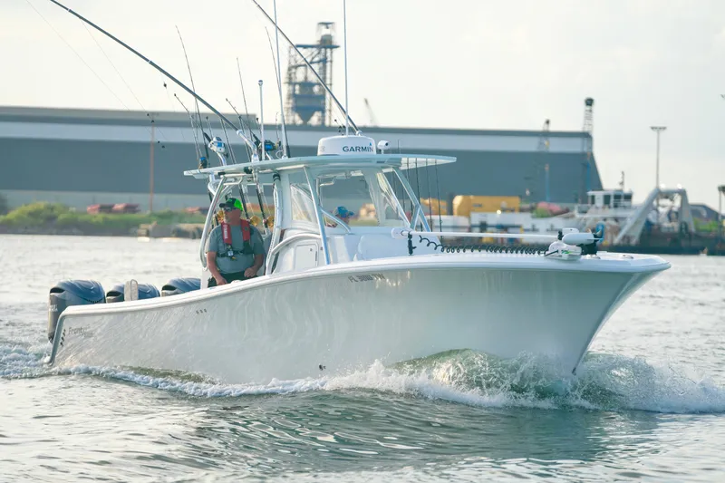 Slide: The Image of 2025 Front Runner 36 Center Console boat cruising in a harbor with fishing gear. - 4