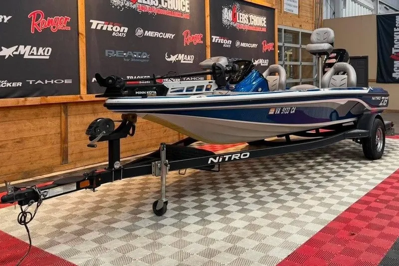 Slide: The Image of 2017 Nitro Z18 boat on display with trailer in showroom setting. - 2