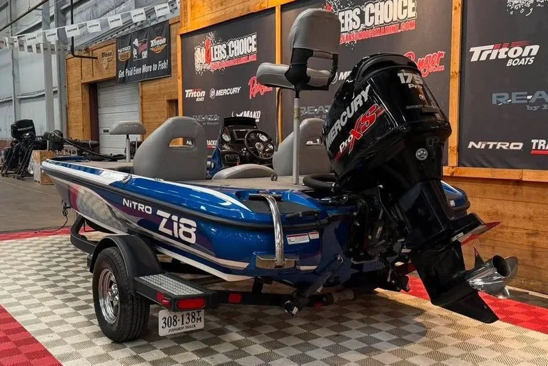 Slide: The Image of Blue 2017 Nitro Z18 boat with Mercury Pro XS engine on display indoors. - 3