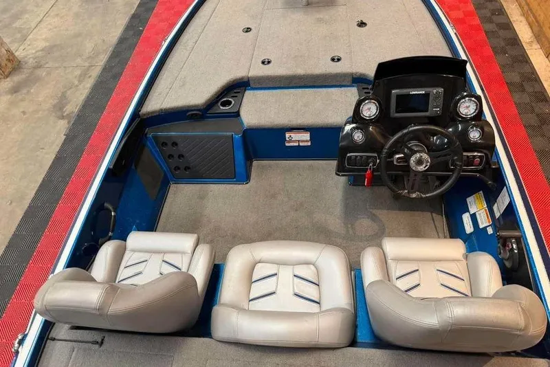 Slide: The Image of 2017 Nitro Z18 boat interior with steering console and three cushioned seats. - 8