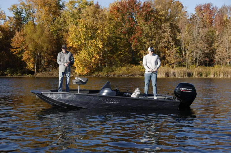 Slide: The Image of Two people fishing on a 2026 Smoker Craft Viper XR 165 boat in autumn scenery. - 1
