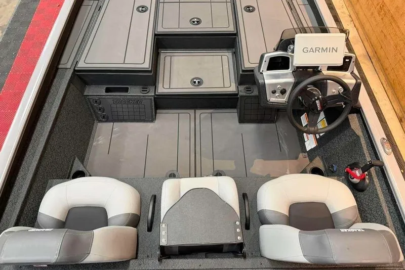 Slide: The Image of 2026 Tracker Savage 215 boat interior with Garmin navigation system and comfortable seating. - 7