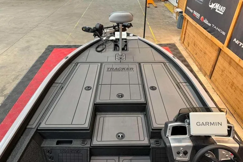 Slide: The Image of 2026 Tracker Savage 215 boat interior with Garmin navigation system in a showroom. - 11