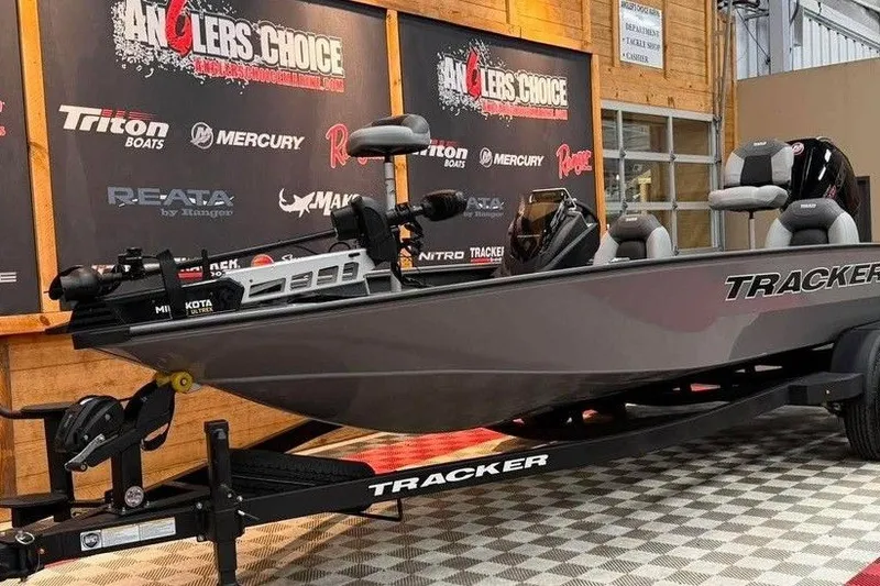 Slide: The Image of 2026 Tracker Savage 215 boat displayed indoors at Anglers Choice event. - 9