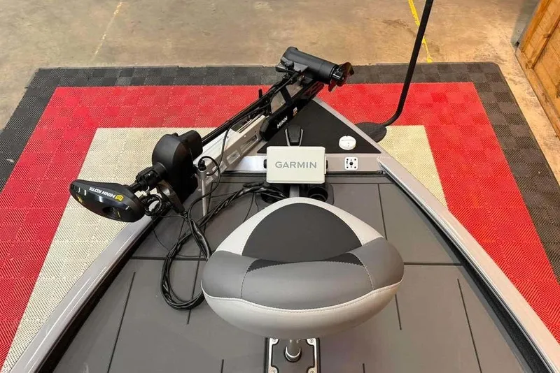 Slide: The Image of 2026 Tracker Savage 215 boat interior with Garmin equipment and Minn Kota trolling motor. - 8