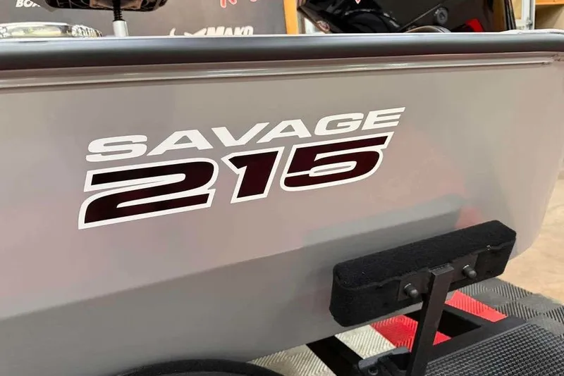 Slide: The Image of 2026 Tracker Savage 215 boat, showcasing bold model branding on the side. - 6