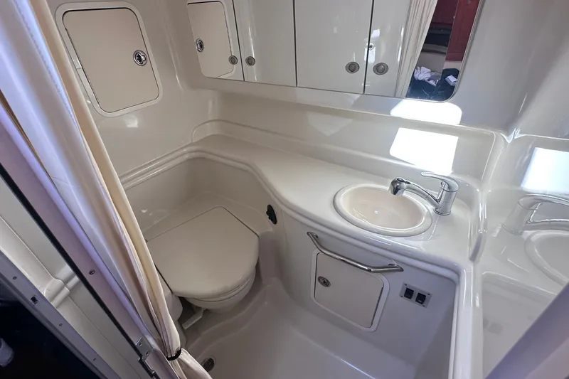 Slide: The Image of 2007 Sea Ray Sundancer 320 bathroom with sink, toilet, and storage cabinets. - 20