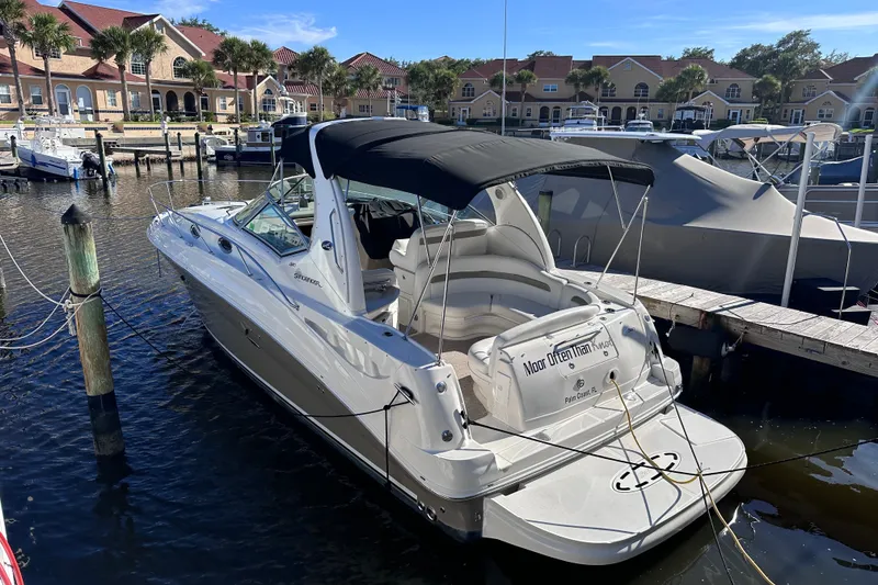 Slide: The Image of 2007 Sea Ray Sundancer 320 docked at marina, featuring sleek design and spacious seating. - 2