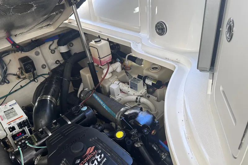 Slide: The Image of Engine compartment of a 2007 Sea Ray Sundancer 320, showcasing mechanical components and wiring. - 24