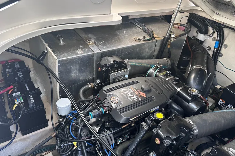 Slide: The Image of Engine compartment of a 2007 Sea Ray Sundancer 320, featuring batteries and mechanical components. - 25