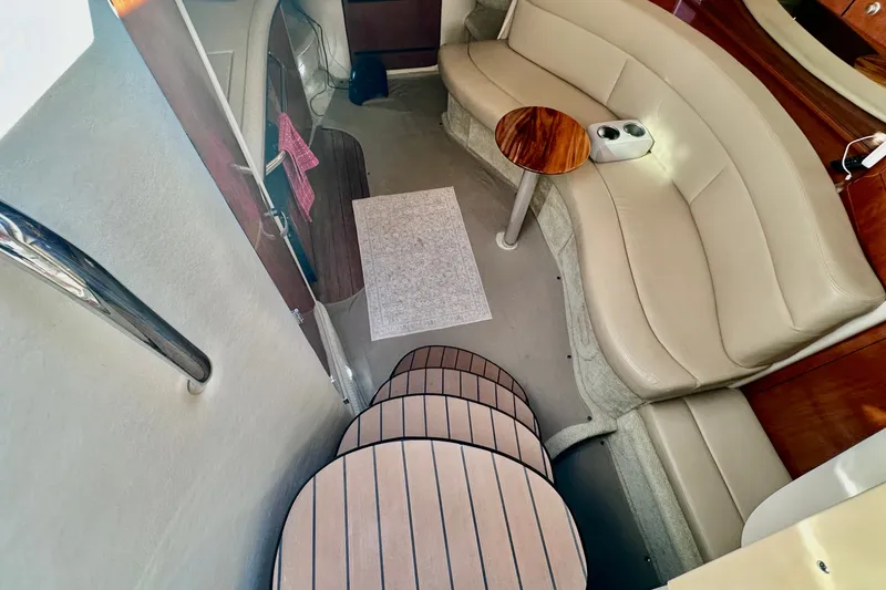 Slide: The Image of Luxurious interior of 2007 Sea Ray Sundancer 320 with beige seating and wooden accents. - 11