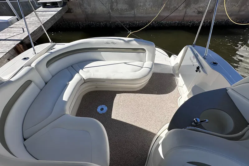 Slide: The Image of 2007 Sea Ray Sundancer 320 boat interior with curved seating and carpeted floor. - 6