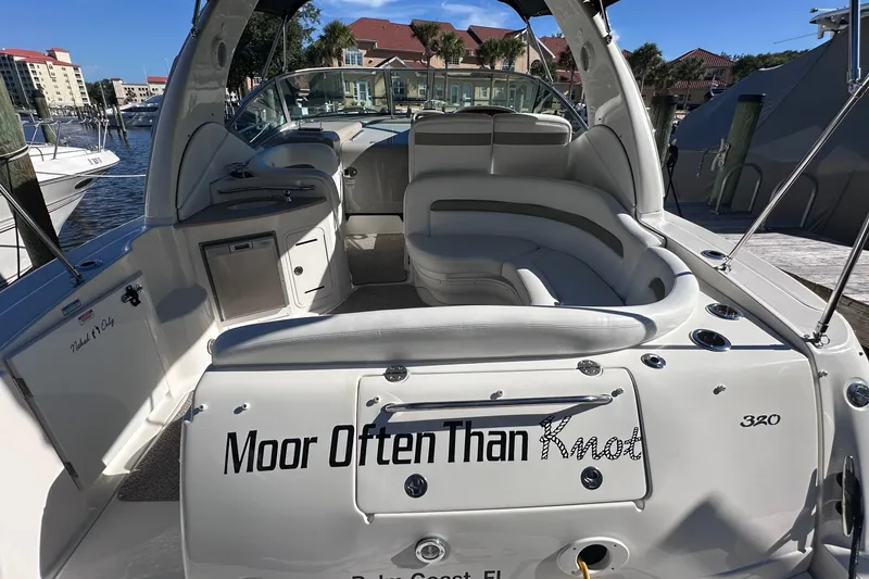 Slide: The Image of 2007 Sea Ray Sundancer 320 boat docked, featuring spacious seating and "Moor Often Than Knot" name. - 5