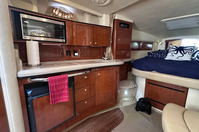 Slide: The Image of Interior of 2007 Sea Ray Sundancer 320 yacht with kitchenette and cozy sleeping area. - 14
