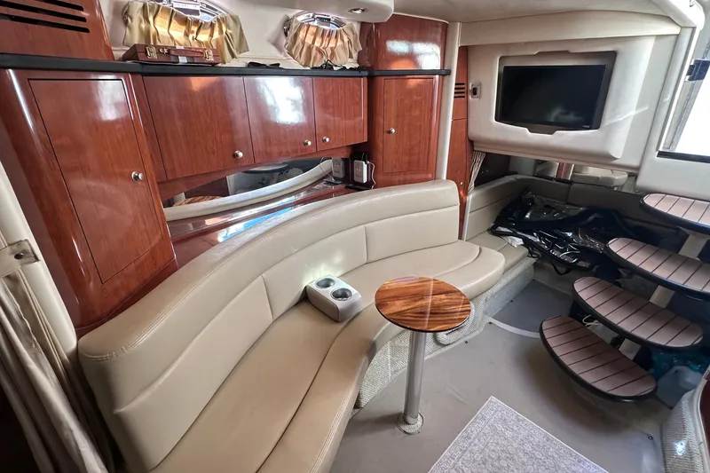Slide: The Image of Luxurious interior of 2007 Sea Ray Sundancer 320 yacht with leather seating and wooden cabinetry. - 12