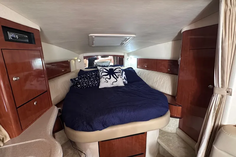Slide: The Image of Luxurious cabin interior of 2007 Sea Ray Sundancer 320 with cozy bedding and elegant wood finishes. - 13