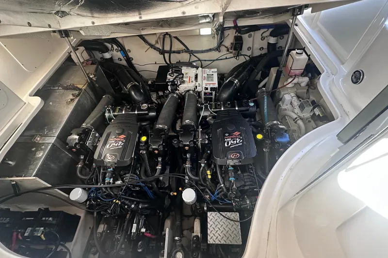 Slide: The Image of Engine compartment of a 2007 Sea Ray Sundancer 320, showcasing dual engines and mechanical components. - 23