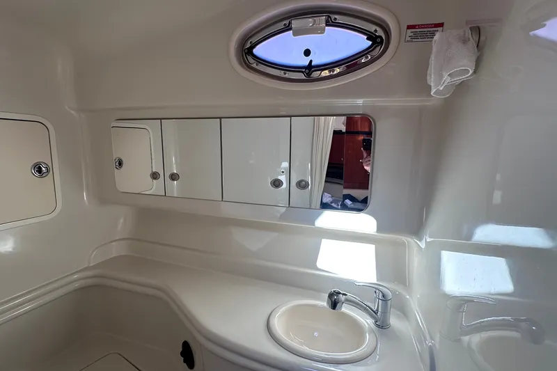 Slide: The Image of Interior of 2007 Sea Ray Sundancer 320 bathroom with sink, mirror, and storage cabinets. - 19