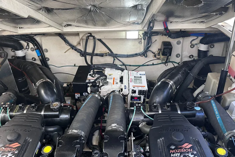 Slide: The Image of Engine compartment of a 2007 Sea Ray Sundancer 320, showcasing dual engines and wiring. - 26