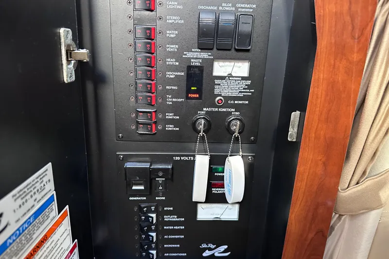 Slide: The Image of Control panel of a 2007 Sea Ray Sundancer 320 boat, featuring switches and ignition keys. - 22