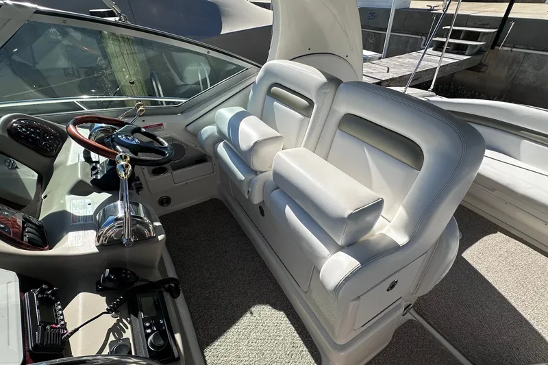 Slide: The Image of 2007 Sea Ray Sundancer 320 cockpit with white seating and steering wheel. - 8