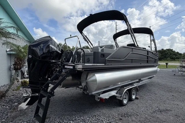 Slide: The Image of 2027 Evotti 523CS pontoon boat on trailer, featuring sleek design and powerful outboard motor. - 10
