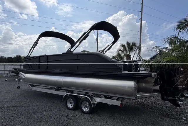 Slide: The Image of 2027 Evotti 523CS pontoon boat on trailer, sleek design, dual bimini tops, parked outdoors. - 8