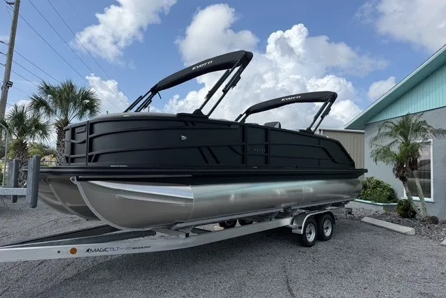 Slide: The Image of 2027 Evotti 523CS pontoon boat on trailer, sleek black design, parked outdoors. - 4