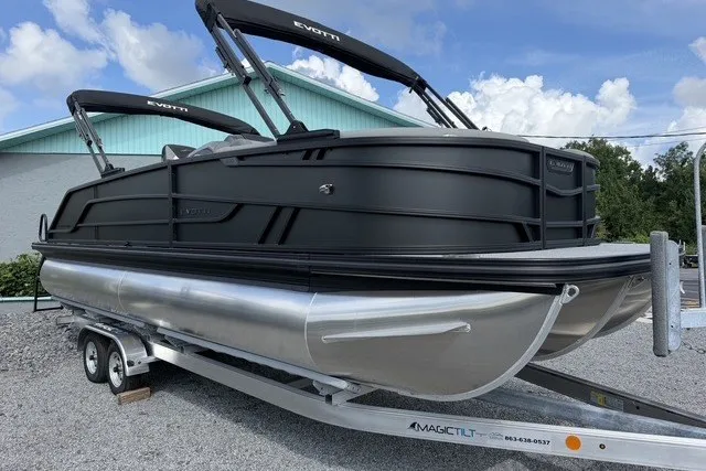 Slide: The Image of 2027 Evotti 523CS pontoon boat on trailer, sleek black design, parked outdoors. - 5
