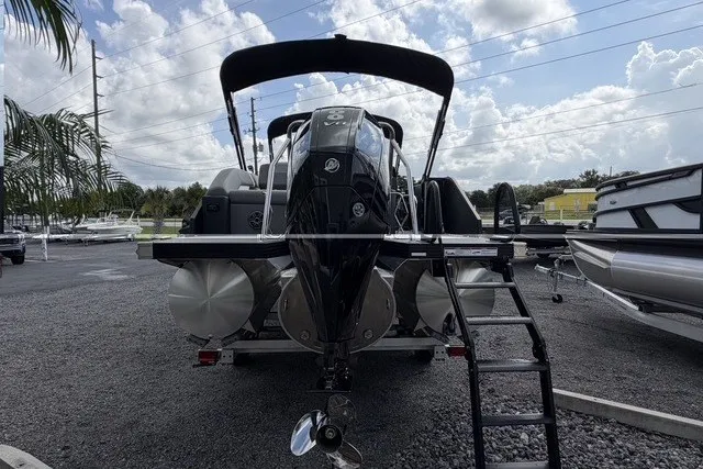 Slide: The Image of 2027 Evotti 523CS boat with outboard motor and ladder, parked on gravel lot. - 9