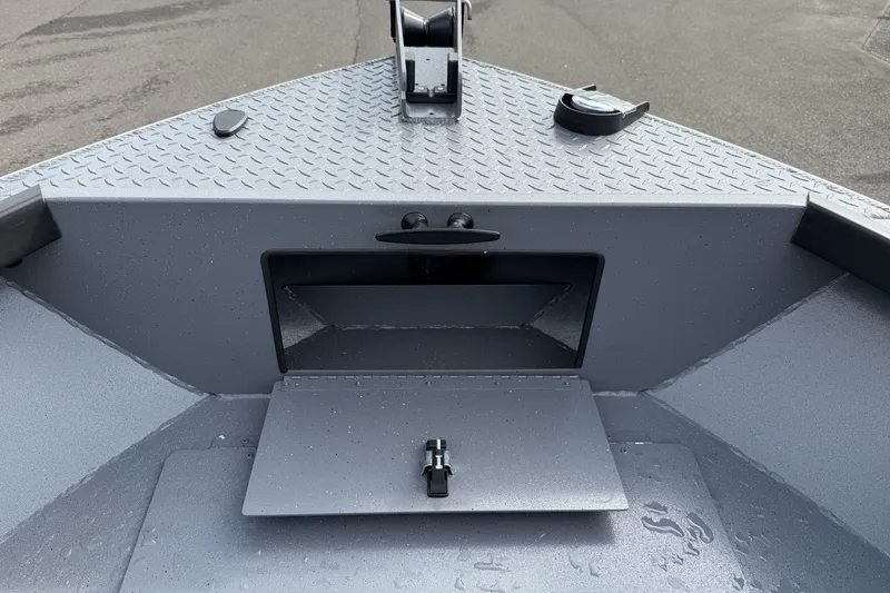 Slide: The Image of Bow storage compartment of 2027 Alumaweld Free Drifter 18 boat, featuring diamond plate surface. - 11