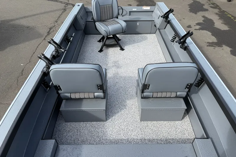 Slide: The Image of 2027 Alumaweld Free Drifter 18 boat interior with gray seating and rod holders. - 7