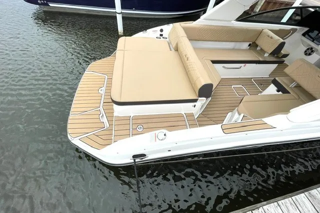 Slide: The Image of 2025 Sea Ray SDX 270 boat with spacious deck and luxurious seating on calm water. - 2