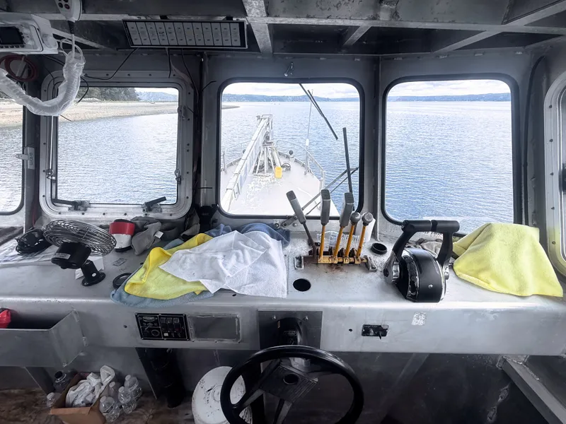 Slide: The Image of Interior view of an aluminum boat with controls and a view of the water. - 6