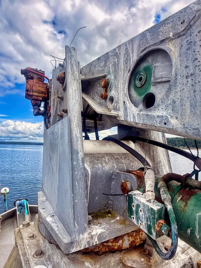 Slide: The Image of Close-up of a rugged aluminum boat with rusty elements and a cloudy sky in the background. - 19