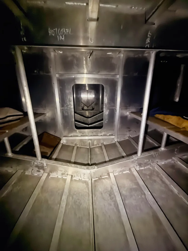 Slide: The Image of Interior view of an aluminum boat with structural reinforcements and shelving. - 11