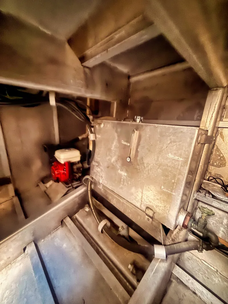 Slide: The Image of Interior view of an aluminum boat with machinery and piping. - 8